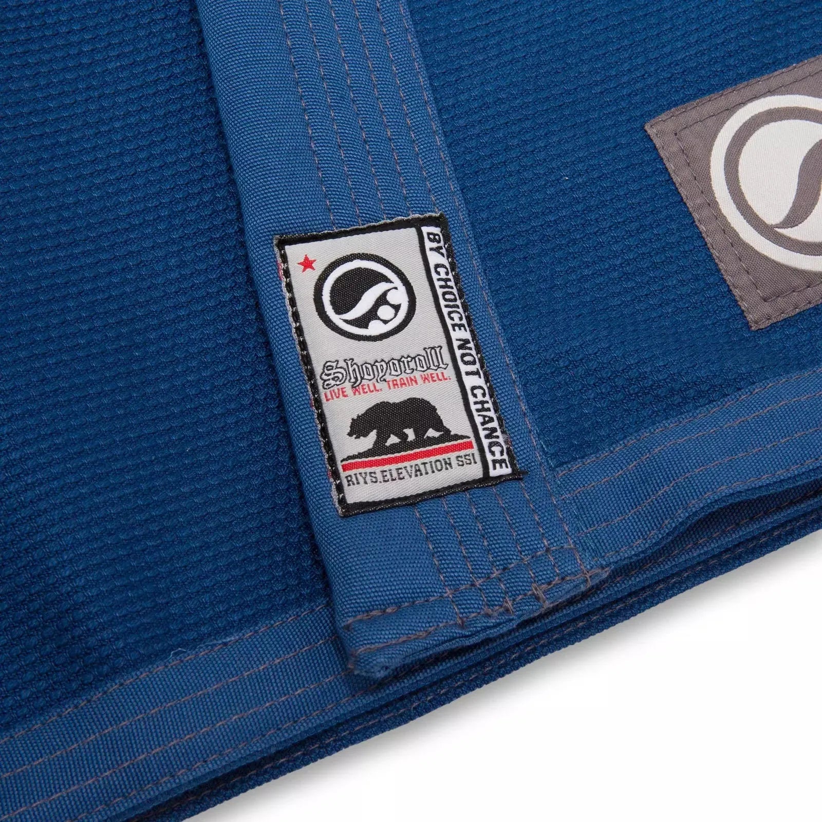 BJJ kimono showing chest patch and blue fabric texture